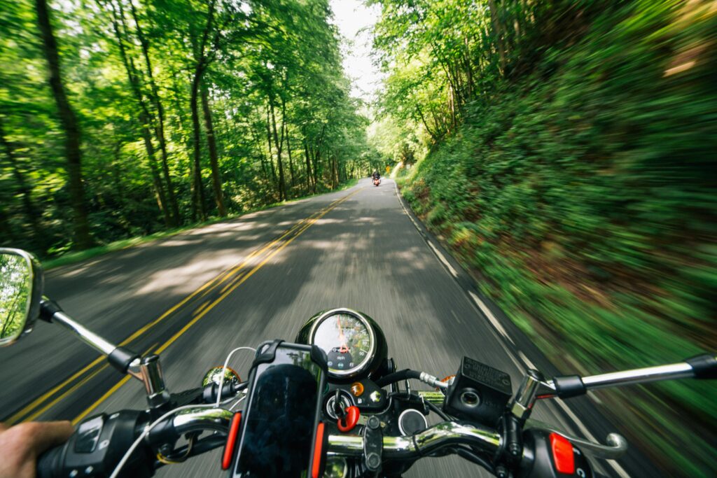 pexels-photo-2396045-2396045 Experience the thrill of speed on a motorcycle journey through lush, winding forest roads.