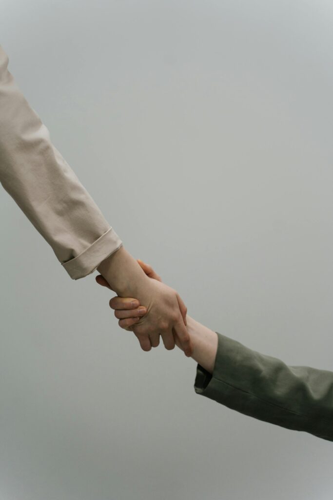 pexels-photo-9463882-9463882 A close-up view of two people shaking hands, symbolizing cooperation and unity, with neutral-toned sleeves.